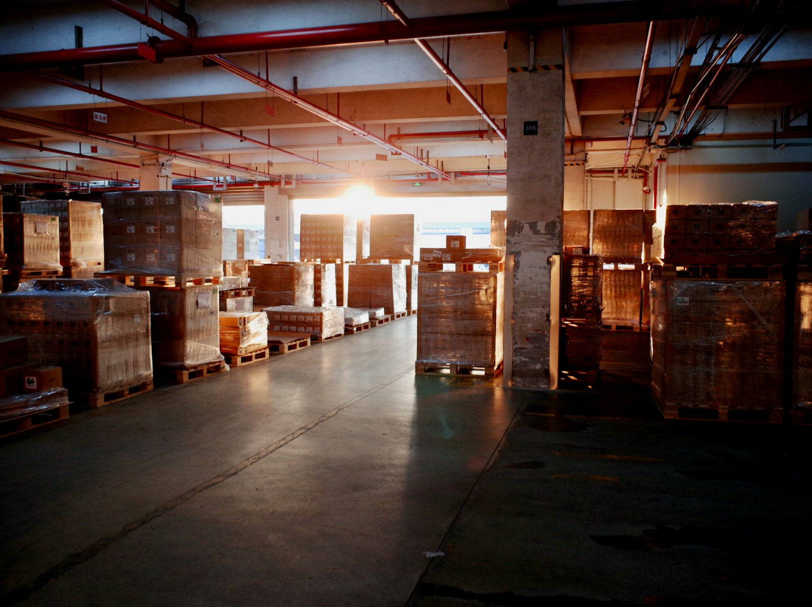 Pallets stacked in a warehouse, standing in for rising volume on an ITAD receiving floor.